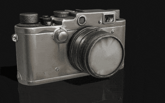 An aluminium camera makes one full turn, showing its 3D shape from every side.